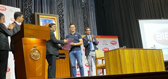 Bhaichung Bhutia is receiving a token of appreciation from BIBS Principal