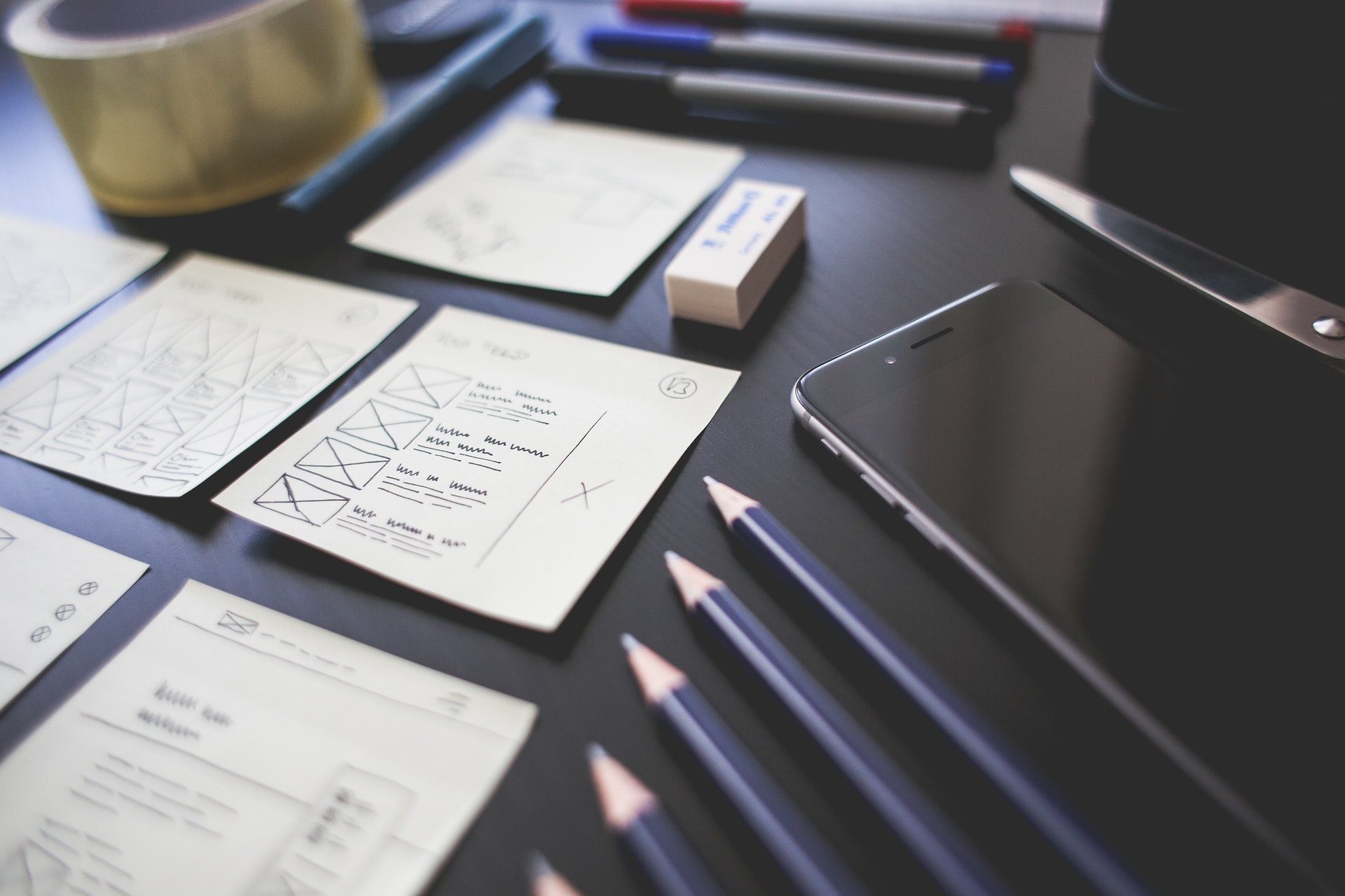 Some quality control checklists, pencils, and a phone are there on the table